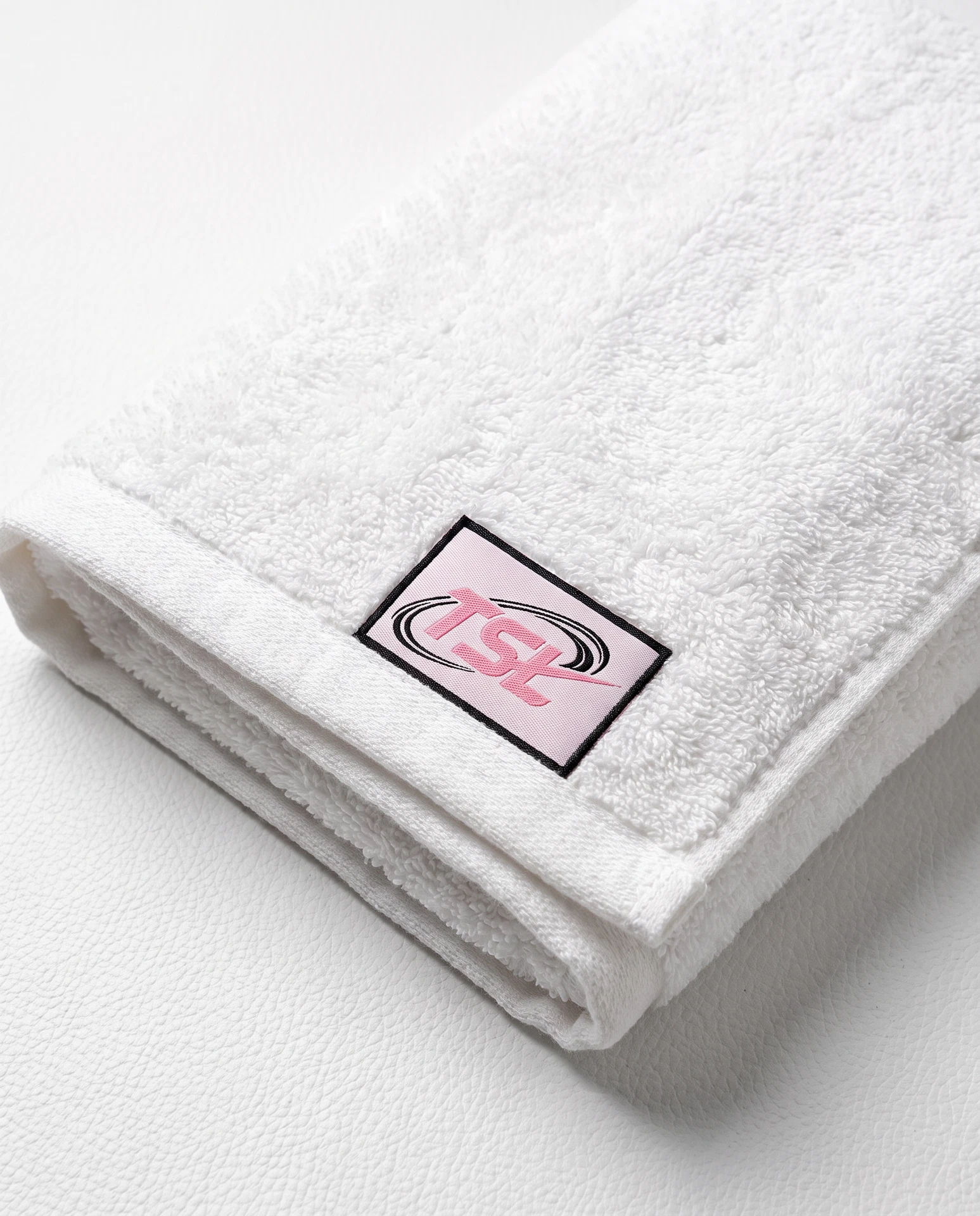 TheSweetLie white towel with pink and black TSL tag